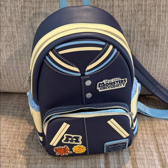 Disney Handbags - Disney Monsters University varsity jacket Navy and Cream Backpack 10 x 8